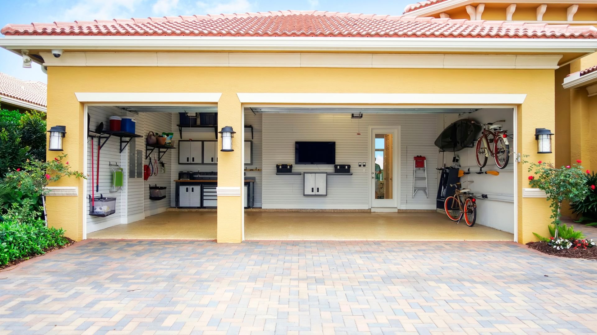 Spacious, well-organized garage with bikes, storage, and white cabinets